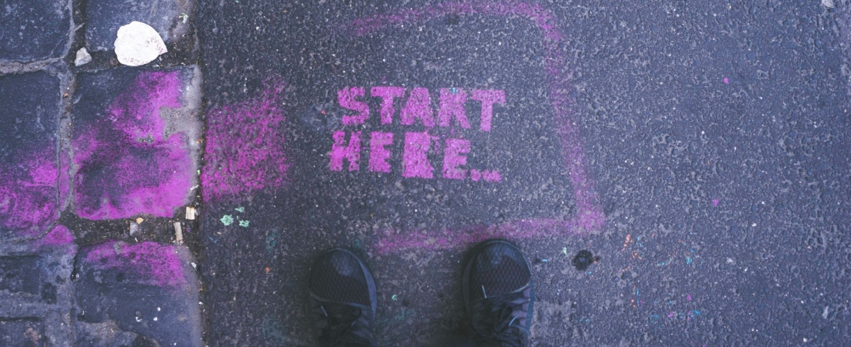 Image of Start Here painted on a pavement